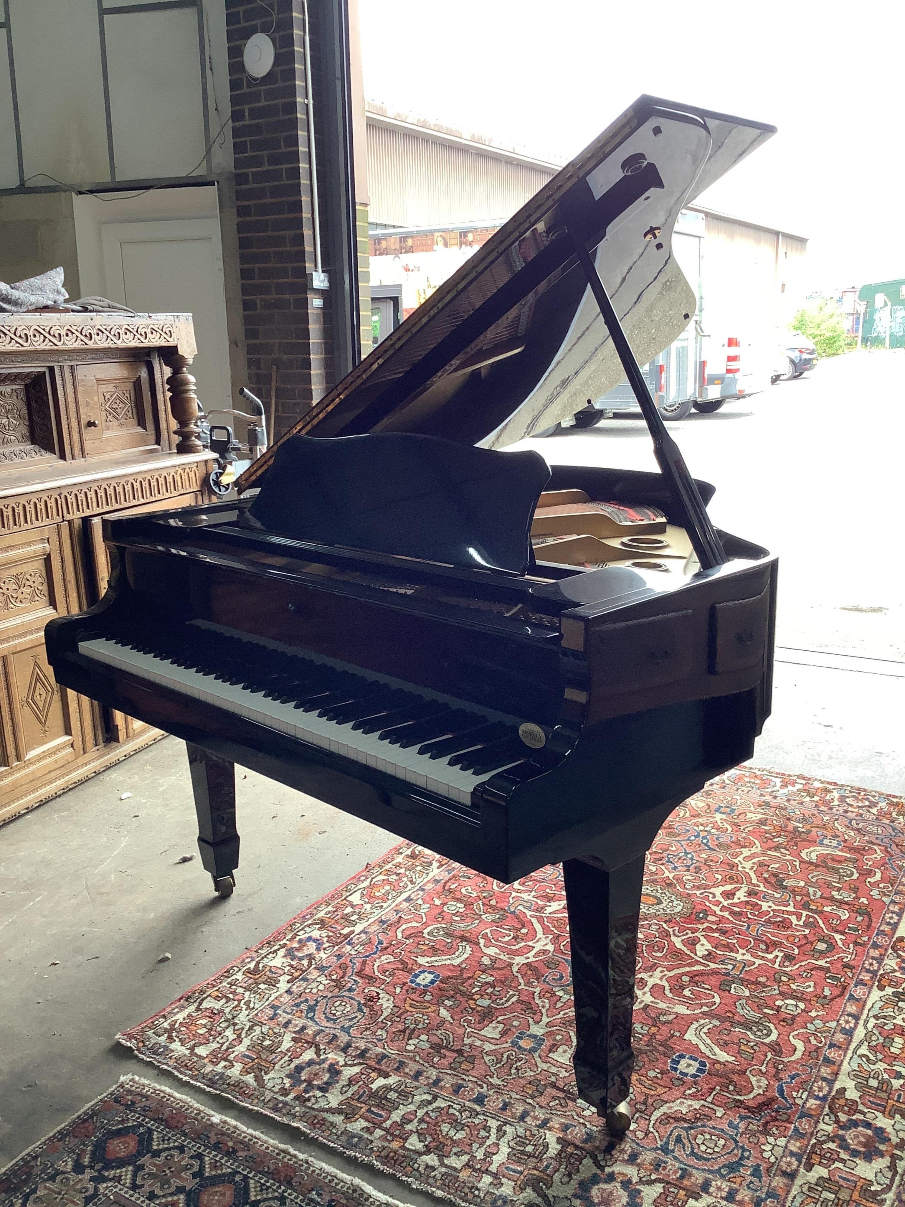 A modern Elysian ebonised baby grand piano, length 160cm, width 148cm, height 101cm, and a duet stool. Condition - good